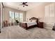 Bright main bedroom with plush carpet, a ceiling fan, and plantation shutters at 5226 S Fairchild Ln, Chandler, AZ 85249