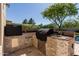 Outdoor kitchen featuring built-in grill, sink, and stone surround at 5226 S Fairchild Ln, Chandler, AZ 85249