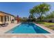 Sparkling pool with surrounding patio, mature trees, and outdoor grilling area for summer gatherings at 5226 S Fairchild Ln, Chandler, AZ 85249