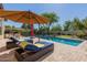 Inviting pool area with lounge chairs and umbrellas, surrounded by lush landscaping, perfect for relaxation at 5226 S Fairchild Ln, Chandler, AZ 85249