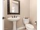 Elegant powder room with pedestal sink and classic fixtures at 5226 S Fairchild Ln, Chandler, AZ 85249