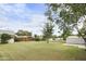 A view of the expansive backyard with lush lawn and mature trees, creating a peaceful outdoor space at 549 N Olive --, Mesa, AZ 85203