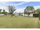 Wide grassy backyard with shed storage and fencing at 549 N Olive --, Mesa, AZ 85203