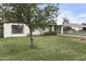 Well-manicured lawn and mature tree compliment this home's charming curb appeal at 549 N Olive --, Mesa, AZ 85203