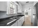 Traditional-style kitchen with stainless steel appliances and view to adjacent living room at 549 N Olive --, Mesa, AZ 85203
