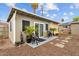 Backyard has chairs on a paver patio, gravel throughout, a building, and some other vegetation at 5519 W Campbell Ave, Phoenix, AZ 85031