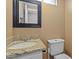 Bathroom featuring granite countertop sink, white cabinets, and a framed mirror at 5519 W Campbell Ave, Phoenix, AZ 85031