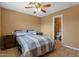 Cozy bedroom with neutral tones, ceiling fan, and en suite bathroom at 5519 W Campbell Ave, Phoenix, AZ 85031