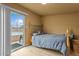 Bedroom featuring a sliding glass door with a view of the pool and a bed with a light wood frame at 5519 W Campbell Ave, Phoenix, AZ 85031