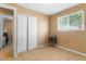 Bedroom with a closet and a window to bring in natural light, with tiled floors and light colored walls at 5519 W Campbell Ave, Phoenix, AZ 85031
