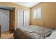 Simple bedroom with closet and window, featuring neutral tones and tile floors at 5519 W Campbell Ave, Phoenix, AZ 85031