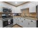 Well-equipped kitchen featuring white cabinets and granite countertops at 5519 W Campbell Ave, Phoenix, AZ 85031