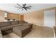 Spacious living room with tile floors, a ceiling fan, and views of the breakfast bar at 5519 W Campbell Ave, Phoenix, AZ 85031