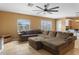 Bright living room featuring a large sectional sofa, ceiling fan, and tile flooring at 5519 W Campbell Ave, Phoenix, AZ 85031