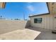 Private backyard with a concrete patio surrounded by stucco walls and white gravel at 5809 E Thomas Rd, Scottsdale, AZ 85251