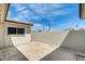 Private backyard with a concrete patio surrounded by stucco walls and white gravel at 5809 E Thomas Rd, Scottsdale, AZ 85251