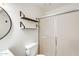 Bright bathroom boasts a glass shower, white fixtures, and open shelving for storage at 5809 E Thomas Rd, Scottsdale, AZ 85251