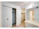 Bright bedroom features a mirrored vanity, closet, and additional storage space at 5809 E Thomas Rd, Scottsdale, AZ 85251
