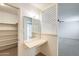 Bedroom featuring a vanity, mirror, and carpet flooring, with an attached closet at 5809 E Thomas Rd, Scottsdale, AZ 85251