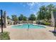 Beautiful community pool area featuring lounging chairs and shaded areas with lush trees at 5809 E Thomas Rd, Scottsdale, AZ 85251