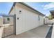 Exterior view of the property, showing the side of the house with a gated walkway at 5809 E Thomas Rd, Scottsdale, AZ 85251