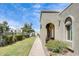 Charming exterior view with stucco finish, an arched entry, and a lovely landscaped walkway at 5809 E Thomas Rd, Scottsdale, AZ 85251