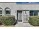 Detailed view of the front door, showcasing the unique security gate and nearby window at 5809 E Thomas Rd, Scottsdale, AZ 85251