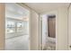 Hallway view into a bedroom with bright windows and a nearby bathroom providing ample living space at 5809 E Thomas Rd, Scottsdale, AZ 85251