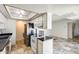 Compact kitchen with white cabinets, stainless steel appliances, and neutral tile floor at 5809 E Thomas Rd, Scottsdale, AZ 85251