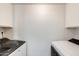 Convenient laundry room with side-by-side washer and dryer hookups and overhead cabinets at 5809 E Thomas Rd, Scottsdale, AZ 85251