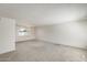 Bright living room features neutral carpet and natural light streaming through a window at 5809 E Thomas Rd, Scottsdale, AZ 85251