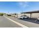 Assigned parking space with a Tesla car parked underneath a covered parking structure at 5809 E Thomas Rd, Scottsdale, AZ 85251
