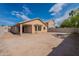 Backyard featuring dirt landscaping, block fence, and covered patio at 6432 S 23Rd Ave, Phoenix, AZ 85041