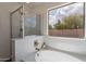 Bathtub with an elegant faucet, a shower and a large window for natural light and pleasant views at 6432 S 23Rd Ave, Phoenix, AZ 85041
