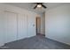 Bedroom features a double closet and a ceiling fan for comfortable living at 6432 S 23Rd Ave, Phoenix, AZ 85041