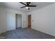 Bedroom with closet and entrance featuring gray carpet and white walls at 6432 S 23Rd Ave, Phoenix, AZ 85041