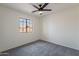 Comfortable bedroom featuring a ceiling fan and a well-lit space with a window at 6432 S 23Rd Ave, Phoenix, AZ 85041