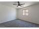 Bedroom with neutral carpet, ceiling fan, and window for ample natural light at 6432 S 23Rd Ave, Phoenix, AZ 85041