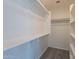 Spacious walk-in closet with built-in shelves and ample storage space at 6432 S 23Rd Ave, Phoenix, AZ 85041