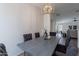 Dining room with modern light fixture and gray chairs at 6432 S 23Rd Ave, Phoenix, AZ 85041