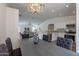 Dining area with dark gray chairs and modern light fixture at 6432 S 23Rd Ave, Phoenix, AZ 85041