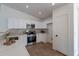 Modern kitchen features white cabinets, stainless steel appliances, and tiled backsplash at 6432 S 23Rd Ave, Phoenix, AZ 85041