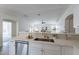 Open concept kitchen with stainless steel appliances, white cabinets, and peninsula with seating at 6432 S 23Rd Ave, Phoenix, AZ 85041