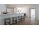 Kitchen features a breakfast bar with seating, white cabinets, and tile flooring at 6432 S 23Rd Ave, Phoenix, AZ 85041