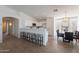 Bright kitchen featuring white cabinets, stainless steel appliances, breakfast bar, and adjacent dining area at 6432 S 23Rd Ave, Phoenix, AZ 85041