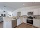 Stylish kitchen with stainless steel appliances, white cabinets and quartz countertops at 6432 S 23Rd Ave, Phoenix, AZ 85041