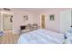 Bedroom with cozy bed, wood floors, art on walls and access to en suite bathroom at 6626 N Majorca E Way, Phoenix, AZ 85016