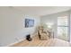 Bright bedroom featuring an accent chair, natural light and wood floors at 6626 N Majorca E Way, Phoenix, AZ 85016