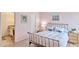 Comfortable bedroom featuring a metal frame bed, soft pink walls, and wood flooring at 6626 N Majorca E Way, Phoenix, AZ 85016