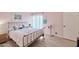 Light-filled bedroom features soft pink walls, wood floors and bright window at 6626 N Majorca E Way, Phoenix, AZ 85016